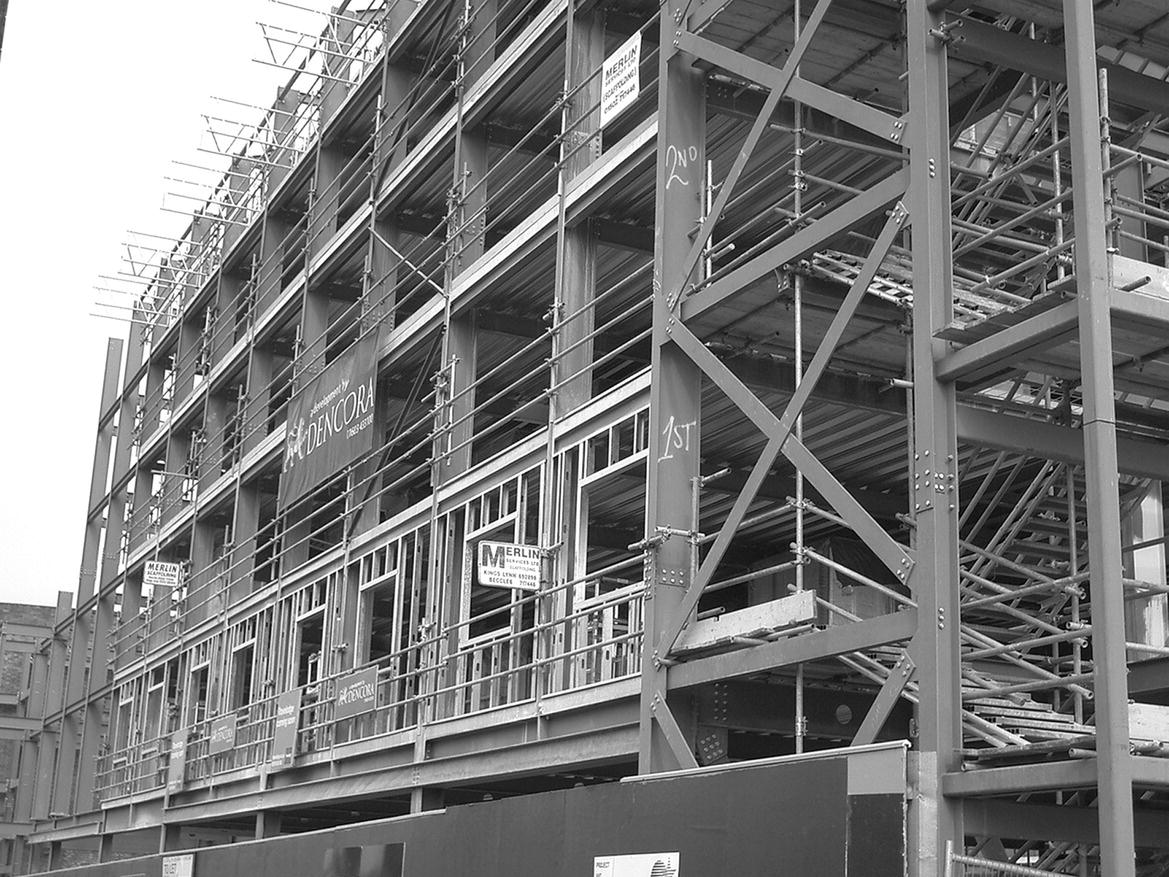 Photo displaying wind bracing to the end of a wall of a multi‐storey skeleton steel frame.
