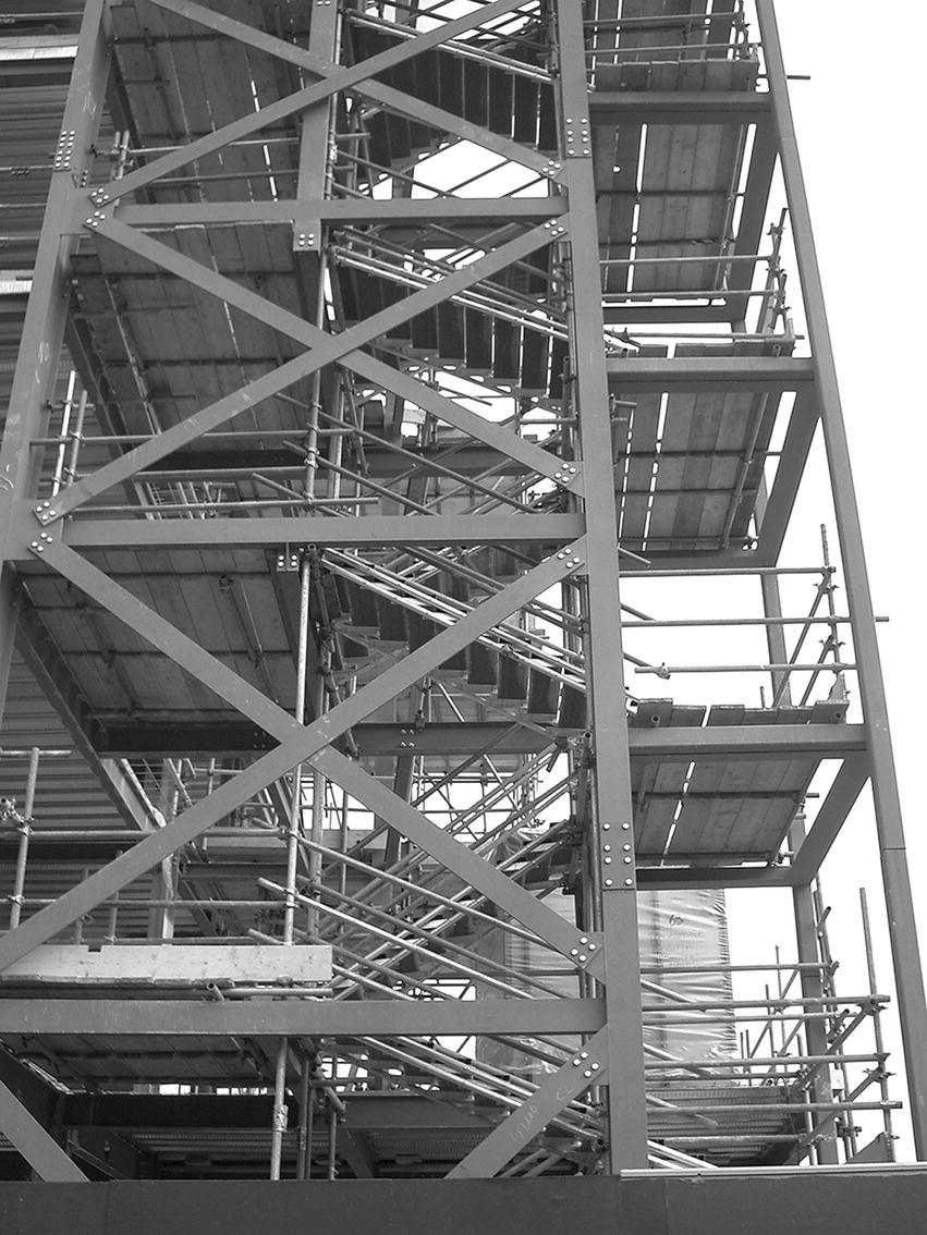 Photo displaying wind bracing around stairs of a multi‐storey skeleton steel frame.