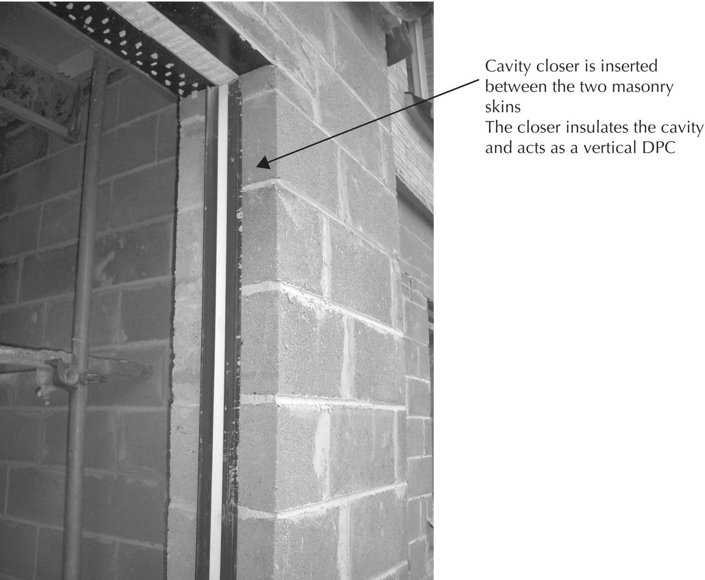 Photo displaying a wall opening pointed by an arrow labeled cavity closer is inserted between the two masonry skins and the closer insulated the cavity and acts as a vertical DPC.