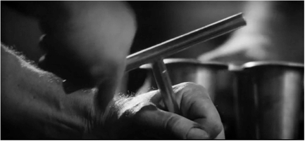 Figure 4.6 Grand Prix: Single image displacement . . . A shot of mechanic tightening a spark plug wrench . Source: Copyright 1966 Metro-Goldwyn-Mayer.