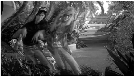Figure 4.20 Wayne’s World: flashback spoof. The Hollywood convention of clearly marking flashbacks is spoofed when Wayne (Mike Myers) and Garth (Dana Carvey) make wavy motions with their hands to indicate a flashback. Source: Copyright 1992 Paramount Pictures.