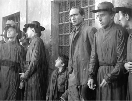 Figure 6.3 Bicycle Thieves (De Sica, 1948): correspondences. Bazin sees correspondences, a kind of meaning that grows a posteriori from the downpour scene when a flock of Austrian seminarians surround the worker and his son. “We have no valid reason to blame them for chattering so much and still less for talking German. But it would be difficult to create a more objectively anticlerical scene.” Source: Copyright 1948 Ente Nazionale Industrie Cinematografiche.