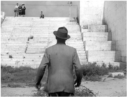 Figure 6.5 Bicycle Thieves (De Sica, 1948): staging in depth. Panicked that his boy has fallen in the river, the father turns and De Sica uses the wide scope and low placement of the camera to make the boy seem somehow more fragile in the eyes of the worried father. Source: Copyright 1948 Ente Nazionale Industrie Cinematografiche.