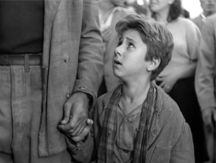Figure 6.8 Bicycle Thieves (De Sica, 1948): medium tracking shot. De Sica returns to his faithful tracking shot to end the film, culminating in a moment where the father bursts into tears. Bruno takes his hand. Bazin writes, “The son returns to a father who has fallen from grace. He will love him henceforth as a human being, shame and all.” Source: Copyright 1948 Ente Nazionale Industrie Cinematografiche.