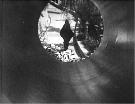 Figure 7.6 Meshes of the Afternoon (Deren, 1943). In Meshes of the Afternoon, Maya Deren signals the beginning of a dream state by a low-tech effect created in front of the lens: the camera dollies back inside a metal pipe. Source: DVD copyright 2002 Mystic Fire Video.