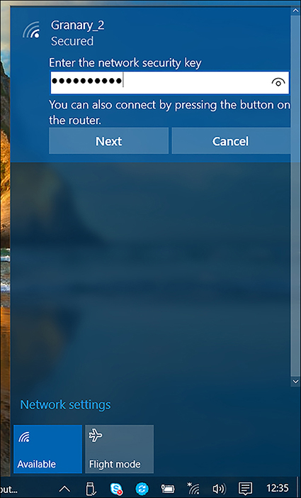 A screen shot shows the security banner for connecting to a wireless network. The password is entered in the Enter The Network Security Key box. Buttons for Next and Cancel are available.