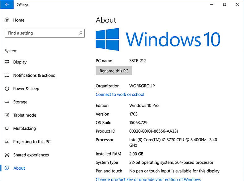 A screen shot shows the System > About screen in the Settings app. The left side of the screen lists the available options, with About highlighted. On the right side of the screen, the Windows 10 logo is at the top of the page, and system information is presented below it, including the Windows 10 version and the operating system build number.