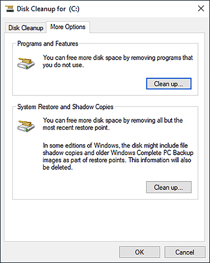 A screen shot shows the Disk Cleanup For (C:) dialog box. In the top half of the dialog box is Programs And Features with a Clean Up button below it. Below this is System Restore And Shadow Copies with a Clean Up button.
