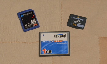 Figure 14.2: Three memory cards for digital storage of photos. Clockwise from bottom, Compact Flash (CF) Card, Secure Digital (SD) Card, eXtreme Digital (xD) Card.