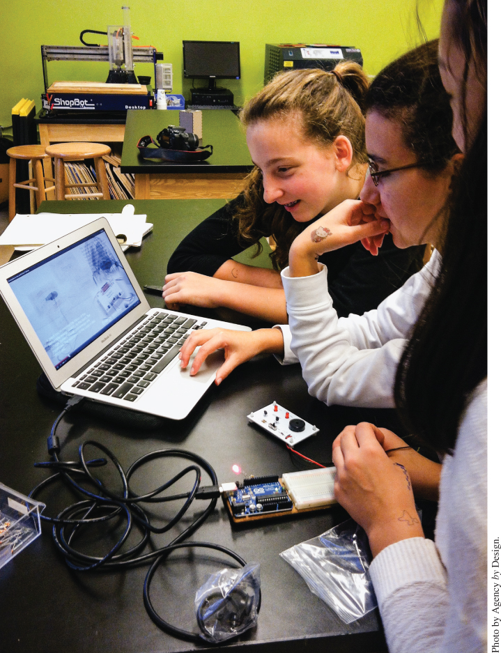 Photo displaying 3 girls facing a laptop and an Arduino-based device.
