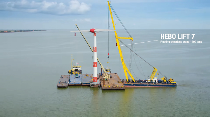Photo displaying offshore vessel and crane positioned near the WTG installation.