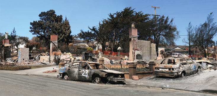 An area in San Bruno, California, with destroyed cars and buildings.