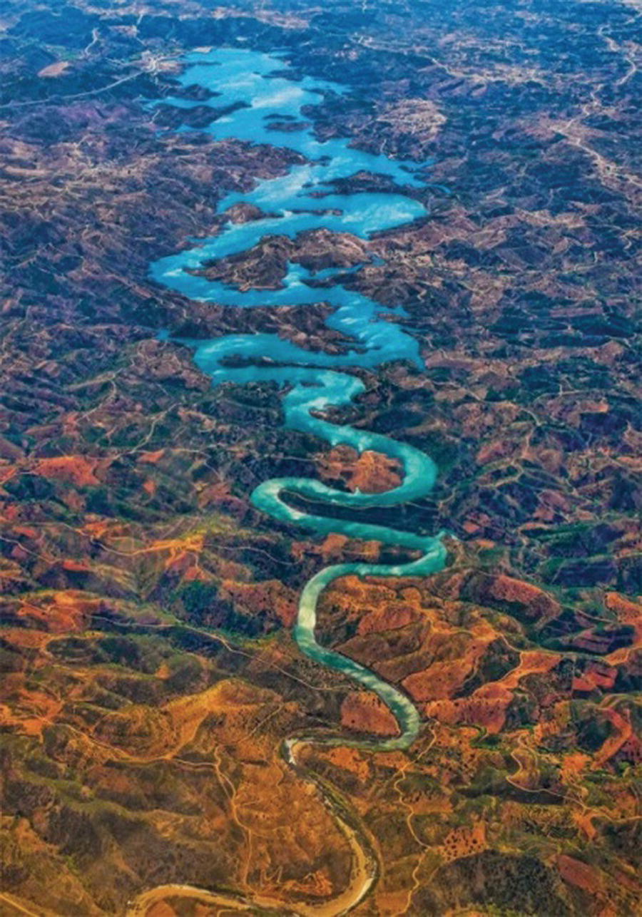 Photo displaying an aerial view of a curved river close to Faro, Portugal.