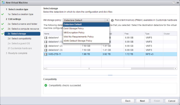 New Virtual Machine Wizard displaying the selected 2c Select storage option on the left and the highlighted Datastore Default option in the VM storage policy drop-down list on the right.