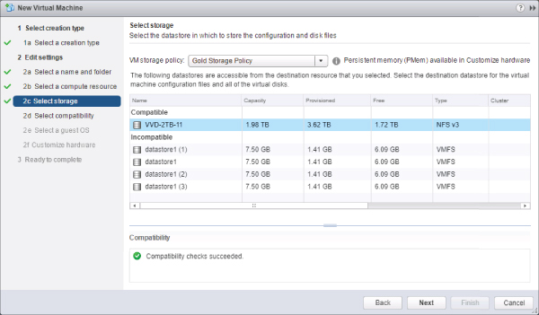 New Virtual Machine Wizard displaying the selected 2c Select storage option on the left and the Gold Storage Policy option in the VM storage policy list on the right. A check mark is labeled Compatibility checks succeeded.