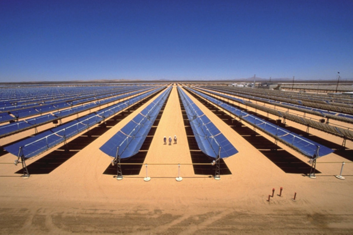 The illustration shows a power plant with solar panels in a desert.