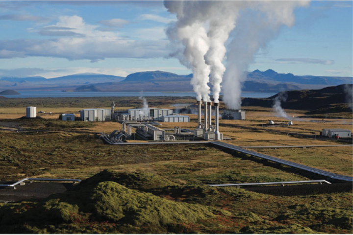Image shows geothermal power plant from which smoke comes out from it.