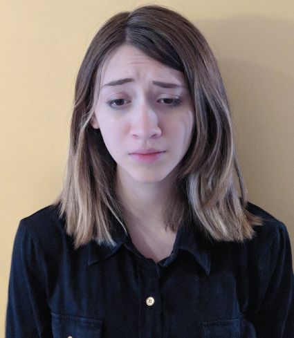 Photograph of a girl expressing sadness in her face and is about to cry.