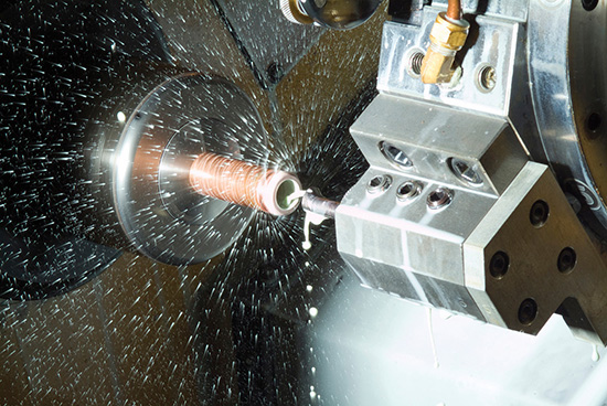 A photo shows an industrial reamer creating precise holes while coolant is being sprayed on the tool and part.