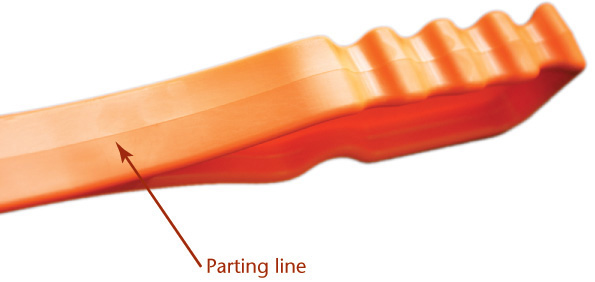 A molded plastic part, with a line at the interconnection of two halves of the part, is shown. The line is labeled parting line.
