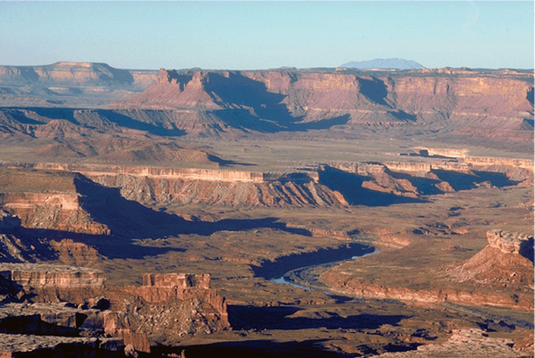 Figure showing aerial perspective, in which atmospheric effects reduce contrast and shift colors toward blue, provides a depth cue over long distances.