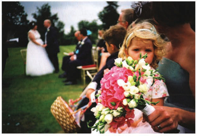 Bouquet In most wedding photos your eye would wander to the bride and groom, but, because of the shallow depth of field, the locus is shifted to the child and the subject of the photo is changed