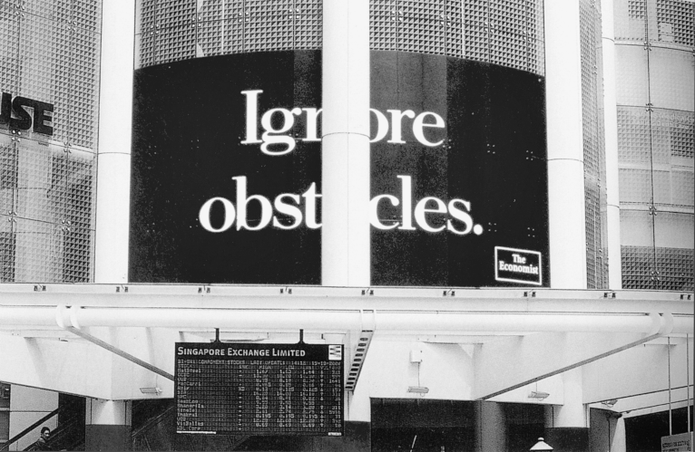 Figure depicting a poster ad of The Economist at the Singapore Exchange Limited that reads, “Ignore Obstacles.” A pillar is present in front of the poster, causing a hindrance in reading the ad.