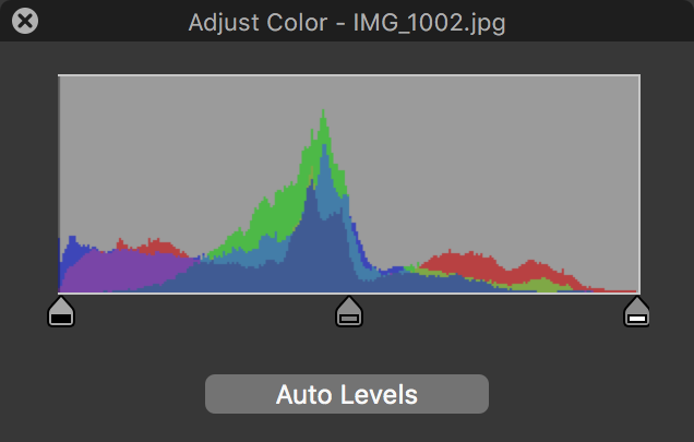 Figure 60: The histogram at the top of the Adjust Color window lets you tweak an image’s black point (left), midpoint (middle), and white point (right) by adjusting the appropriate drag handle.