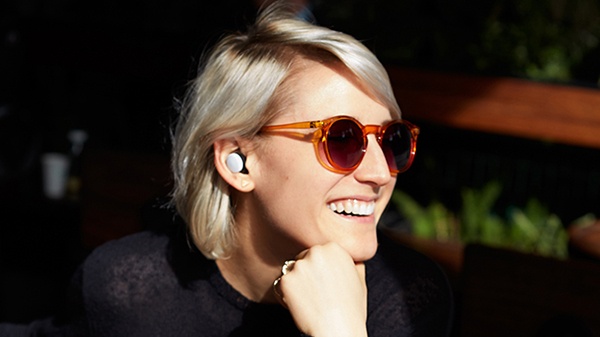 Woman wearing sensory augmentation earbuds by Here One