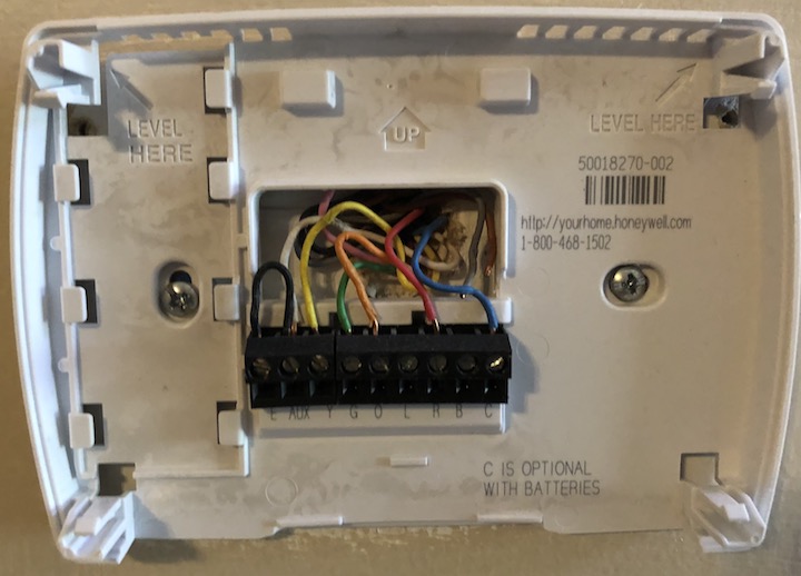 Figure 54: For my HVAC system, the C-wire is the blue one. Note how the thermostat mount says “C is optional with batteries”—most thermostats that use batteries don’t need the additional power the C-wire provides.