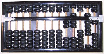 A photograph shows “Abacus,” with some of its beads moved to perform the addition operation of digit 7 to the digit 5.