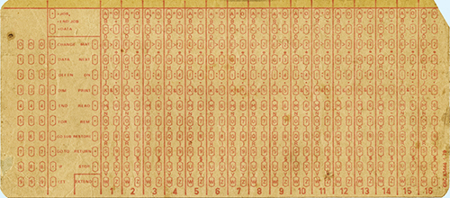 A photograph shows a Hollerith card with holes punched in them.