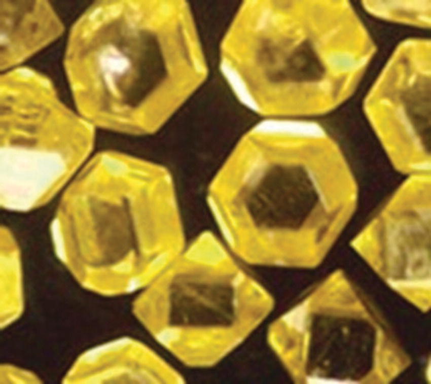 Photo of diamond powders synthesized by the HPHT method depicted as hexagonal particles.