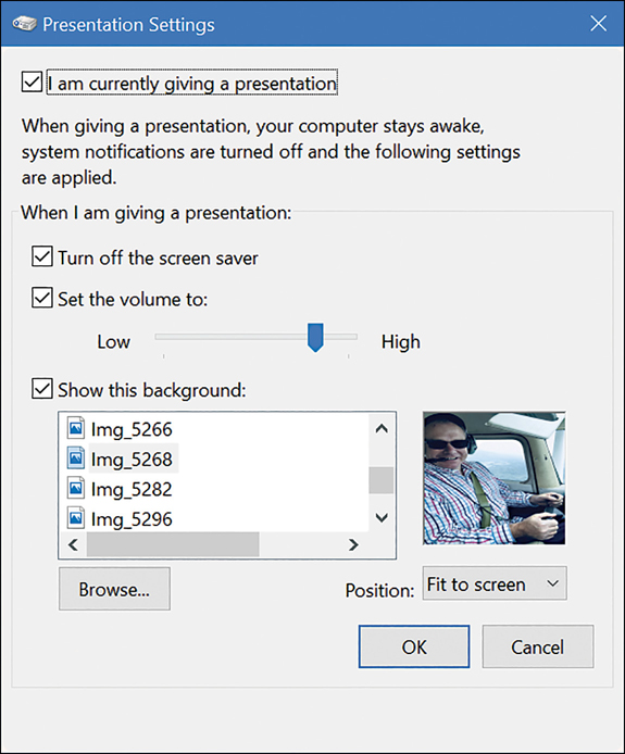 A screenshot shows the Presentation Settings dialog box. The options are: I Am Currently Giving A Presentation (selected), When I Am Giving A Presentation Turn Off The Screen Saver (Selected), Set Volume To, and Show This Background. The Show This Background option includes a Browse button which allows you to choose an image. A thumbnail of the chosen image appears at the right.