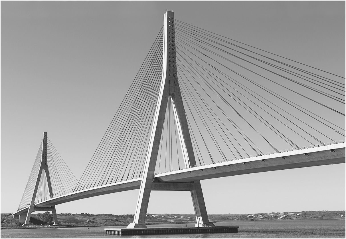 A cable stay bridge over a body of water, cables extend outward from central braces.
