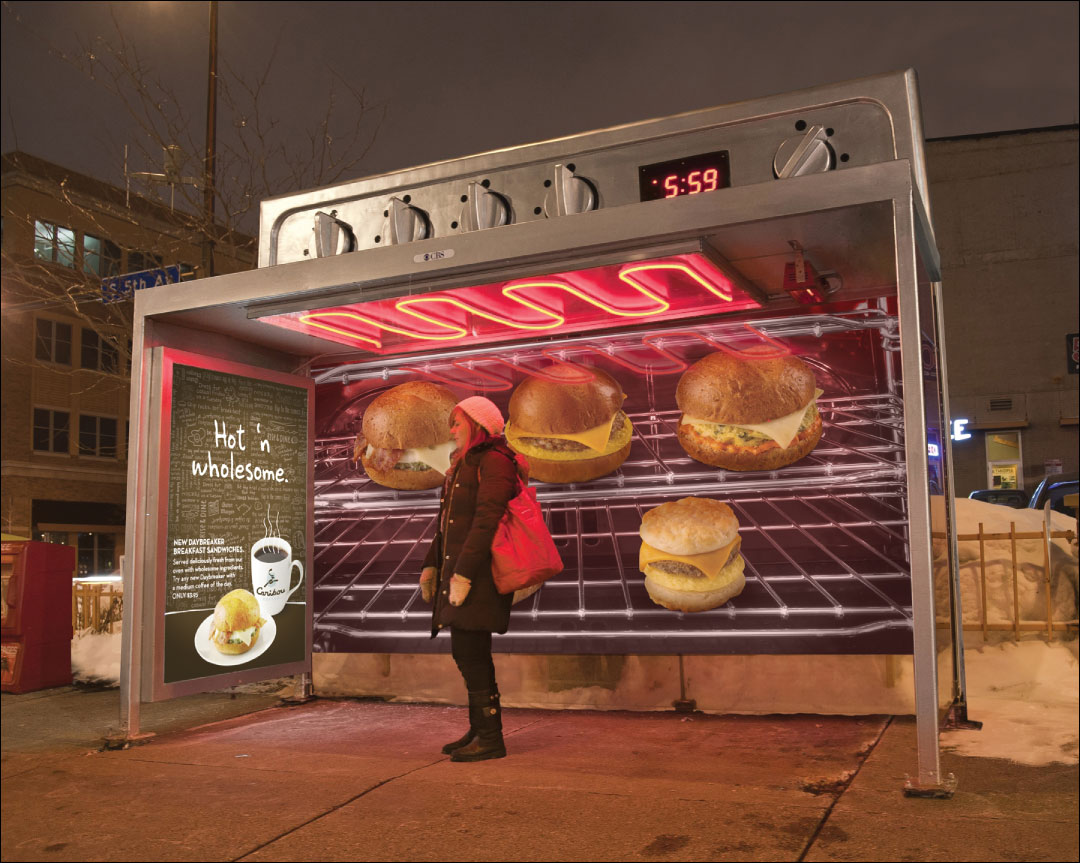 Photo shows a woman standing in a bus shelter which advertises Caribou Coffee on its sides and shows the photo of hot breakfast sandwiches in an oven on its rear. The top of the shelter is being heated.