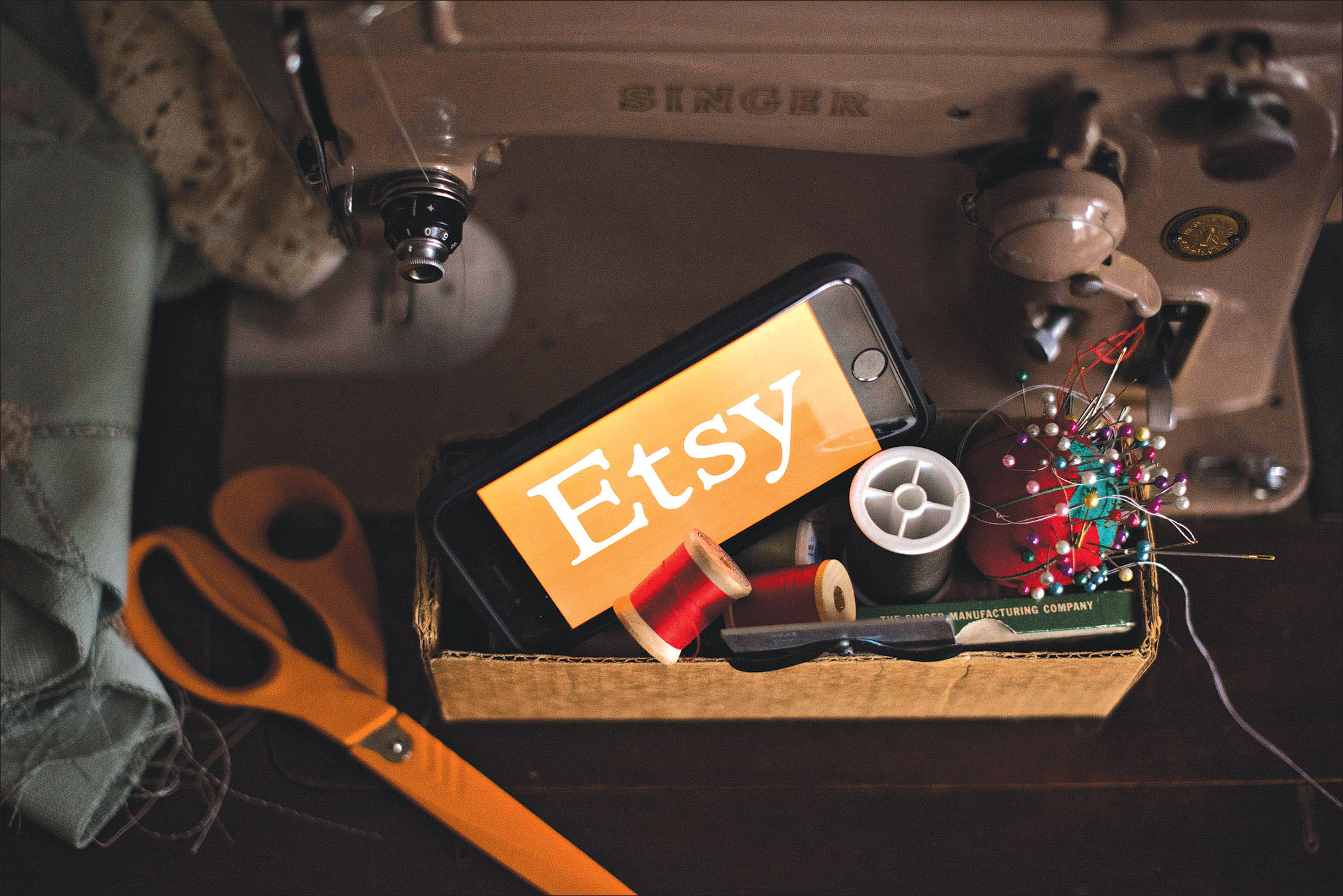 Etsy advertisement shows a sewing machine along with bobbins of thread and scissors.