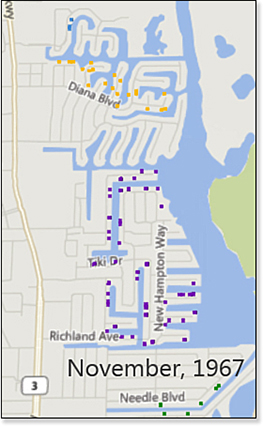 This figure is a map of four neighborhoods in Merritt Island, Florida. The time label indicates November 1967 and about 50 houses are plotted on the map. Each neighborhood is a different color. Because the map is viewed from overhead, you cannot see any height variation between the columns. This example continues in Figure 24.10.