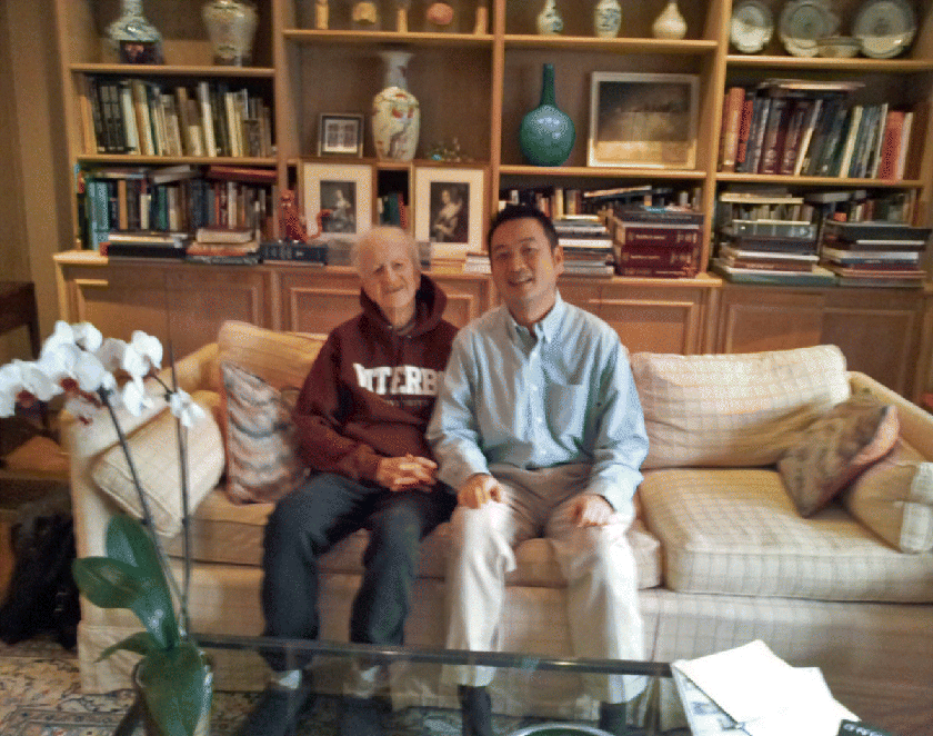 Photograph depicting author James Liang (left) with Gary Becker (right) sitting on sofa.