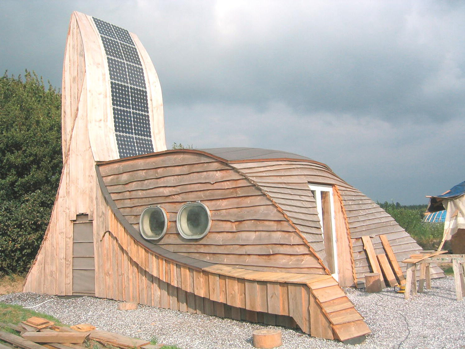 A wooden house with a solar panels on the roof in Denmark.