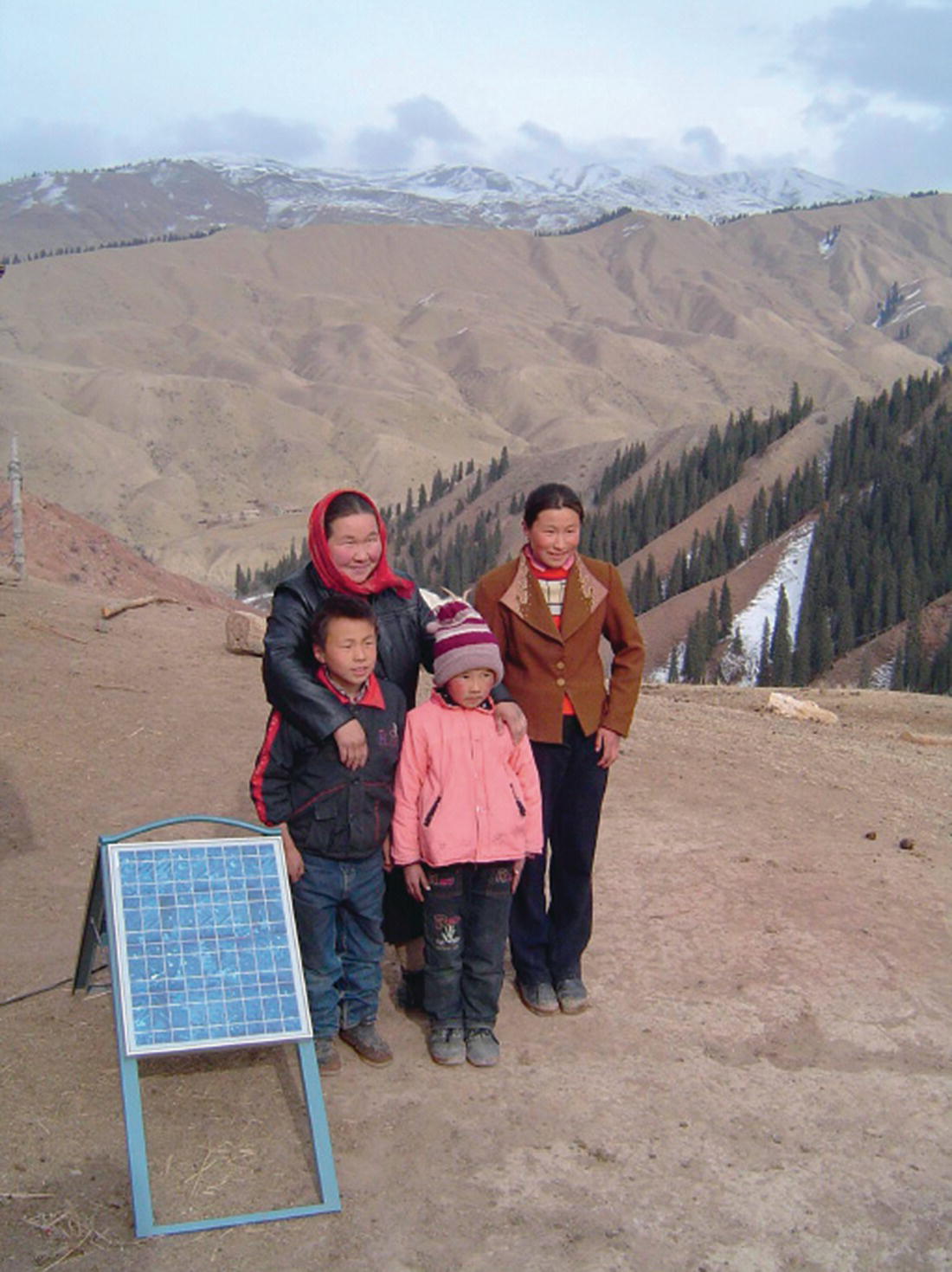 A family in China with a PV solar panel at there right.