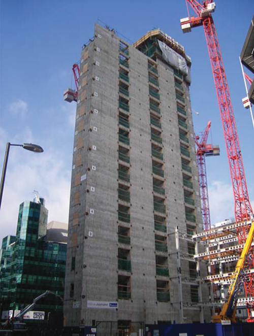 Photo showing View from the south-east corner of slip-form core construction progressed to level 15 of 21, with the first four-storey bay of steelwork commenced.