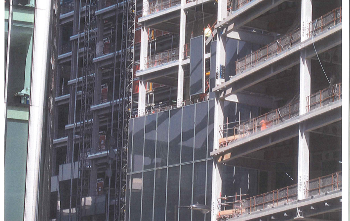 Photo of façade panels being hoisted into place.